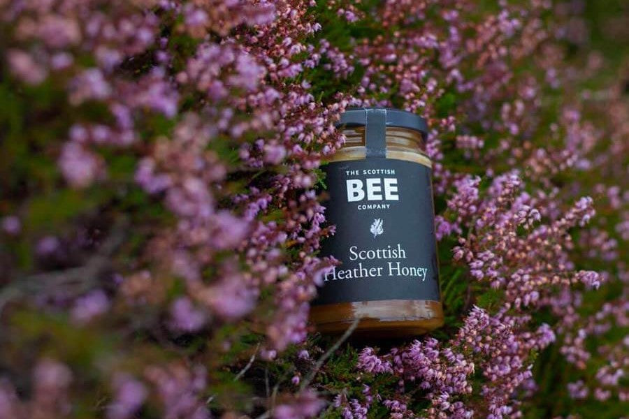 A jar of Scottish Heather Honey in a heather moor
