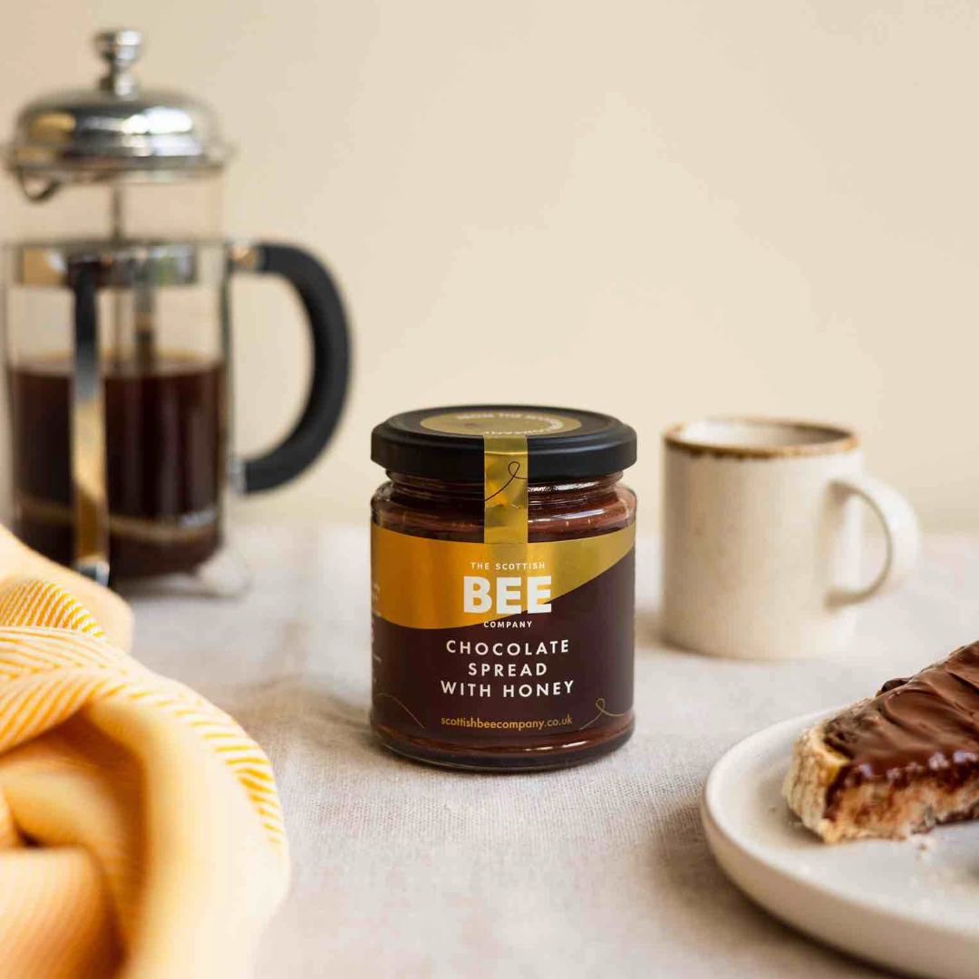 chocolate spread with honey next to toast and coffee