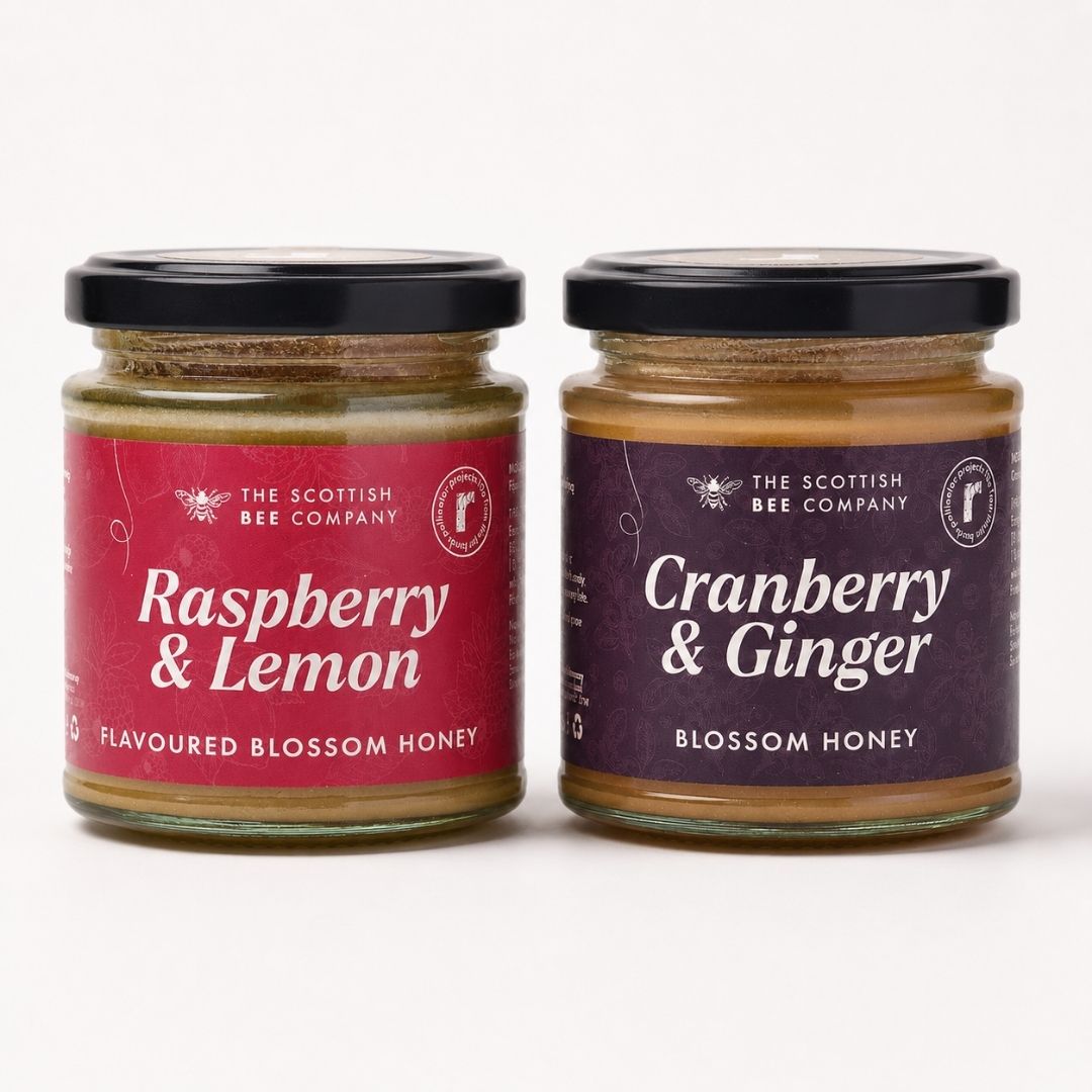 scottish bee company raspberry and lemon honey and cranberry and ginger honey on a plain background