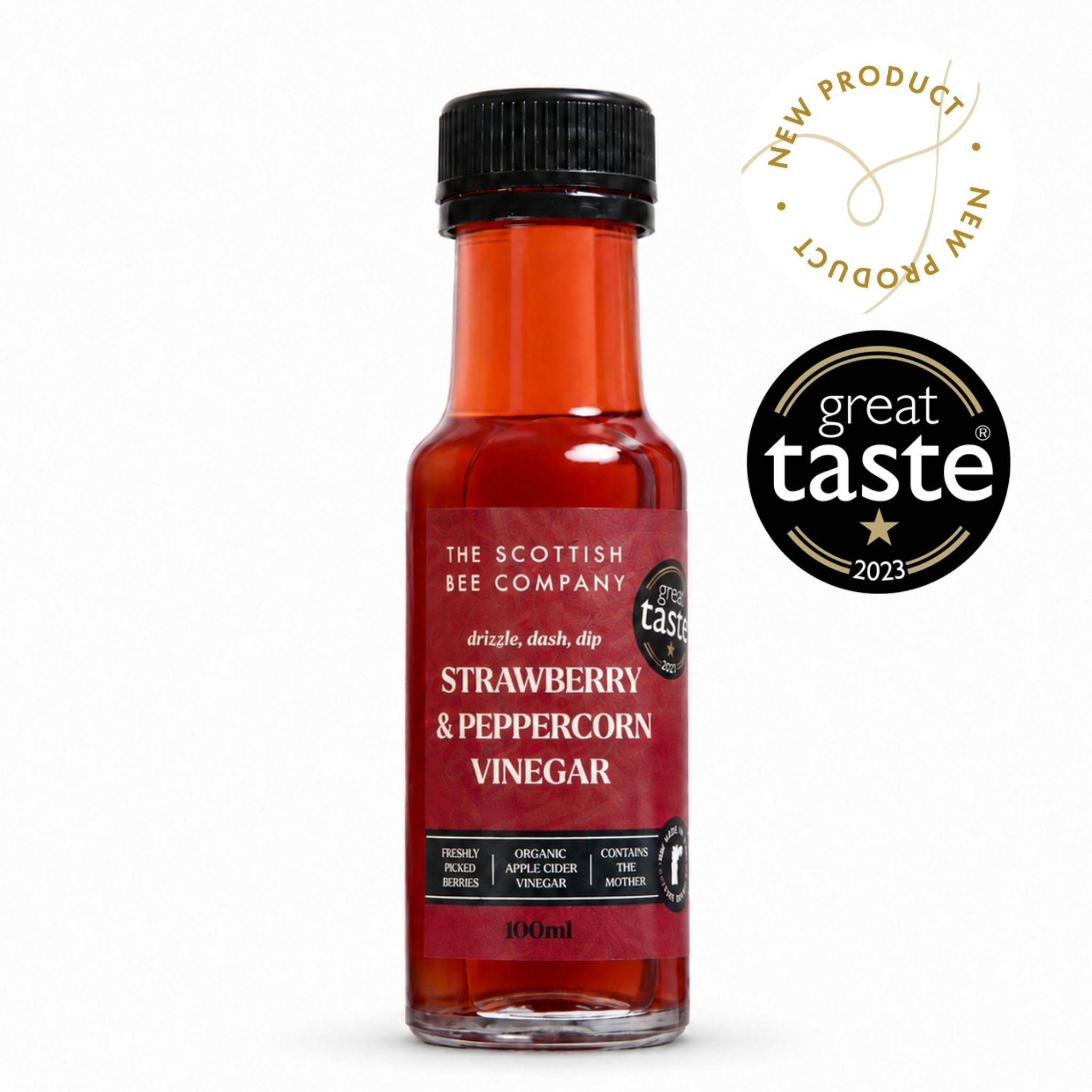 A 100ml bottle of Strawberry & Peppercorn Vinegar by The Scottish Bee Company, featuring a black cap and a red label, shown on a white background with a &