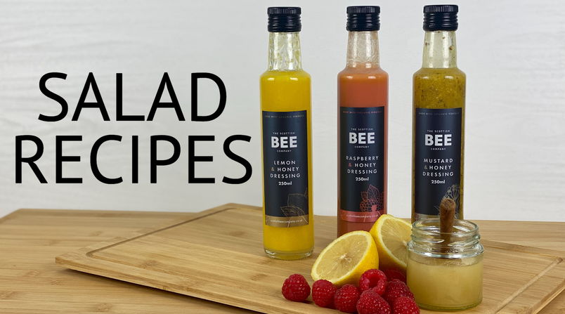 Salad Recipe blog header with three salad dressing bottles and raspberries, lemon and honey jar in front