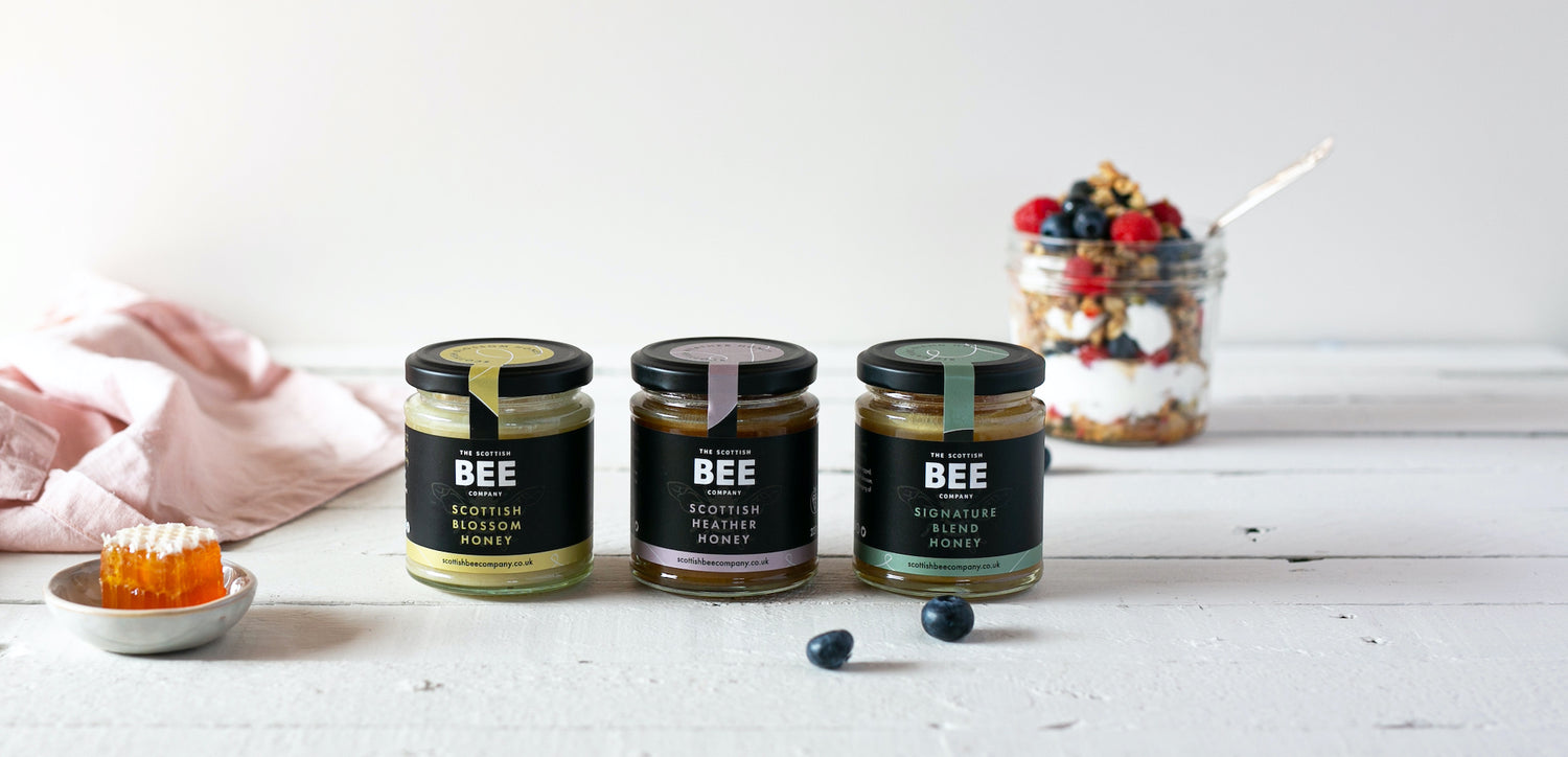 Blossom, Heather and Signature Honey Jars on light background with granola and yogurt
