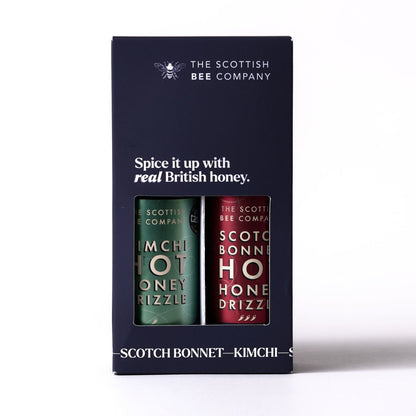 Packaging of The Scottish Bee Company honey with two jars inside on a white background. Contains Kimchi Hot Honey Drizzle and Scotch Bonnet Hot Honey Drizzle