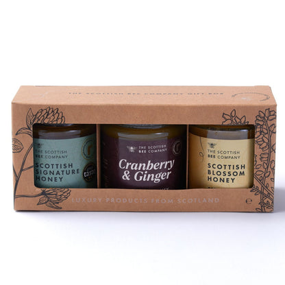 Three honey jars in a cardboard packaging with &