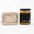 Jar of Scottish Heather Honey and a container of honeycomb on a white background
